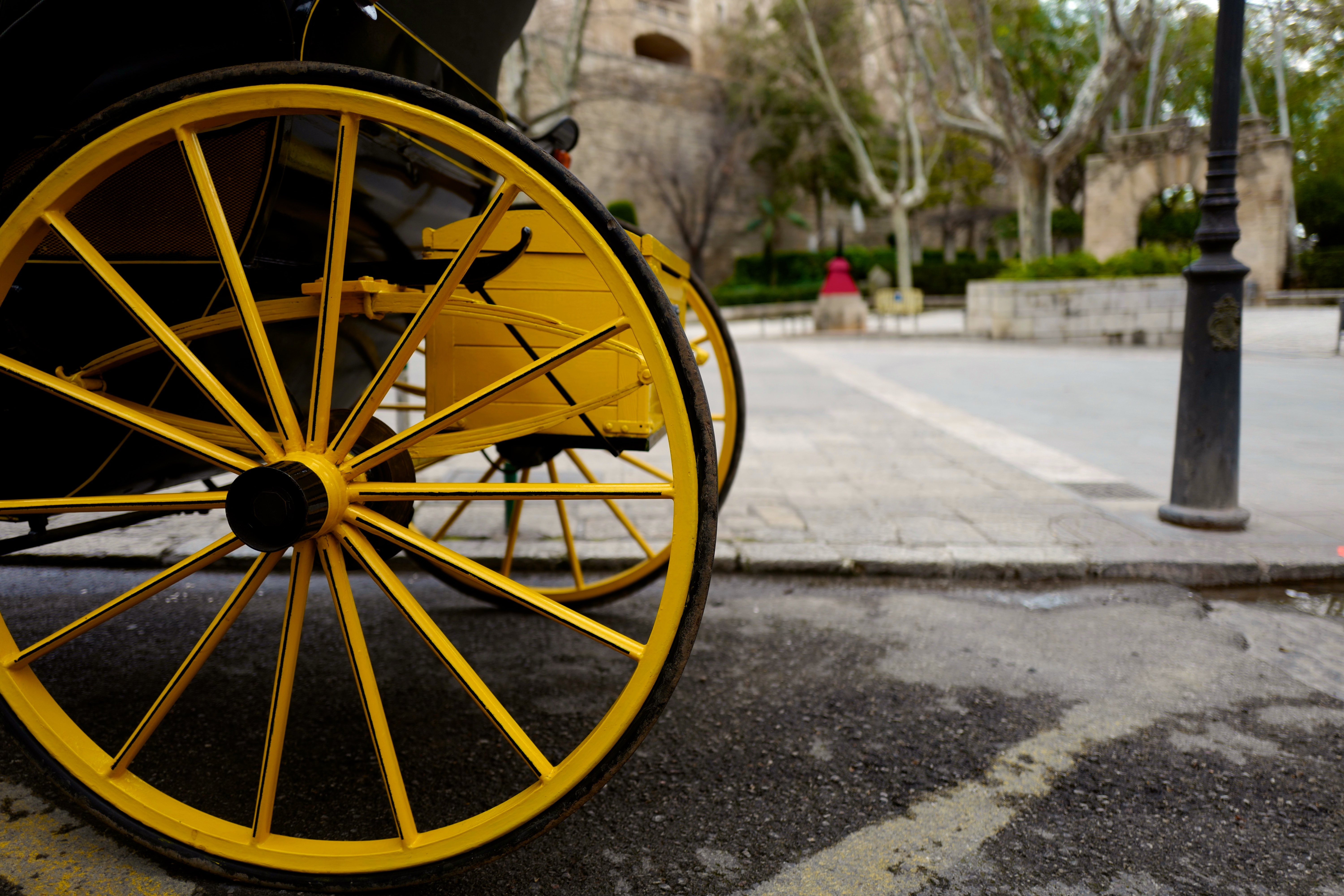 Yellow wheels from a carriage parked up