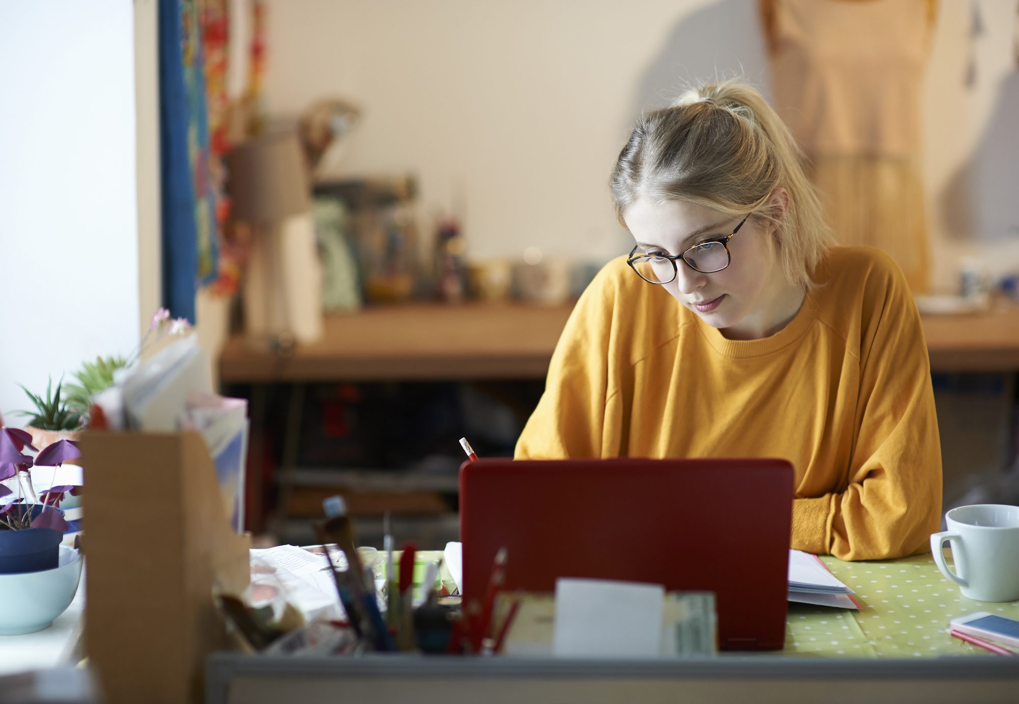 Fair-haired woman working on laptop at home