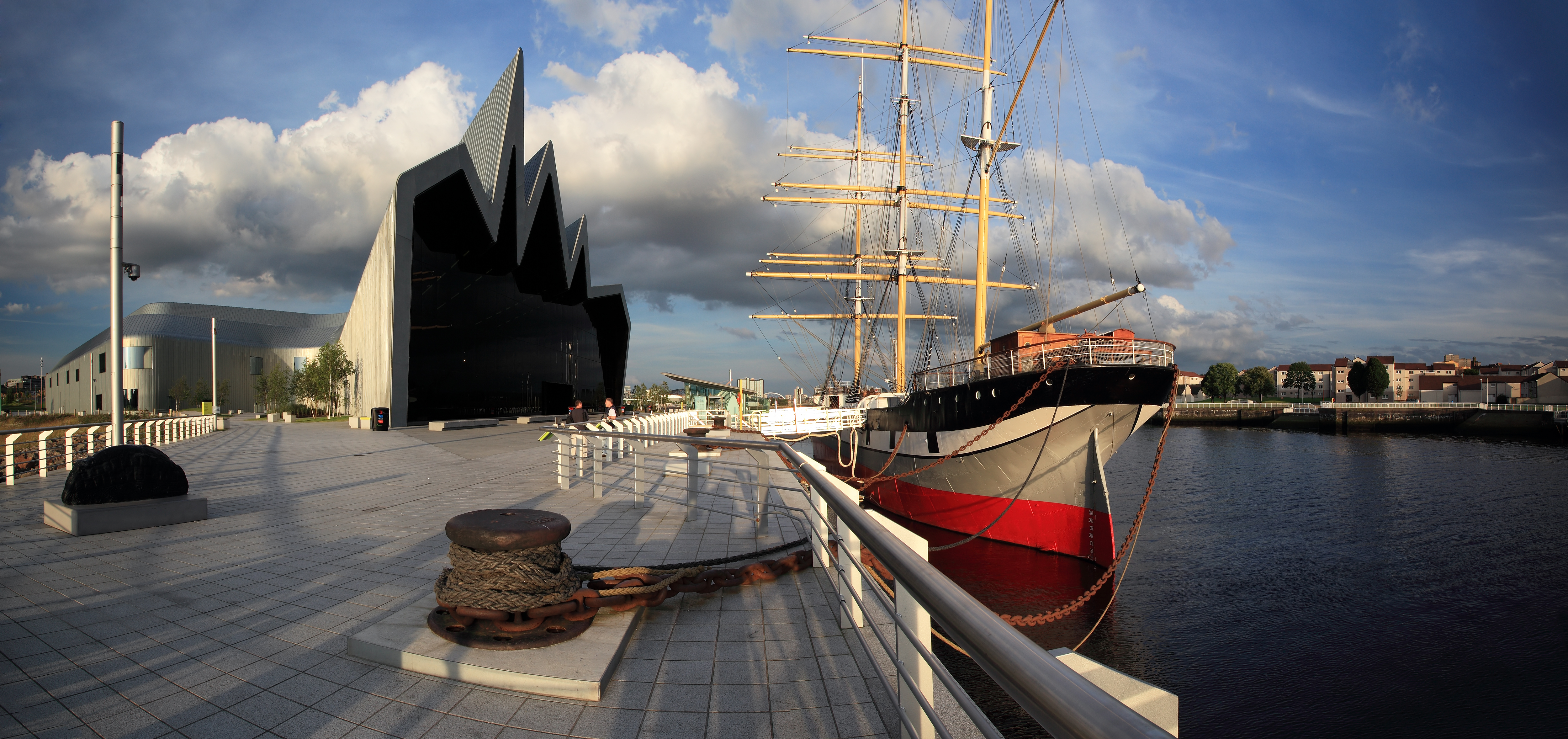 View of a ship docked outside the ultramodern Riverside Museum in Glasgow, Scotland