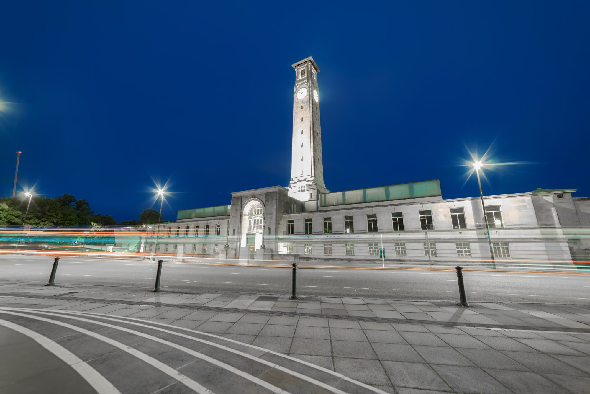Dusk image of the Civic Centre in Southampton with its tall clock tower; long exposure so that lights are streaking across the image