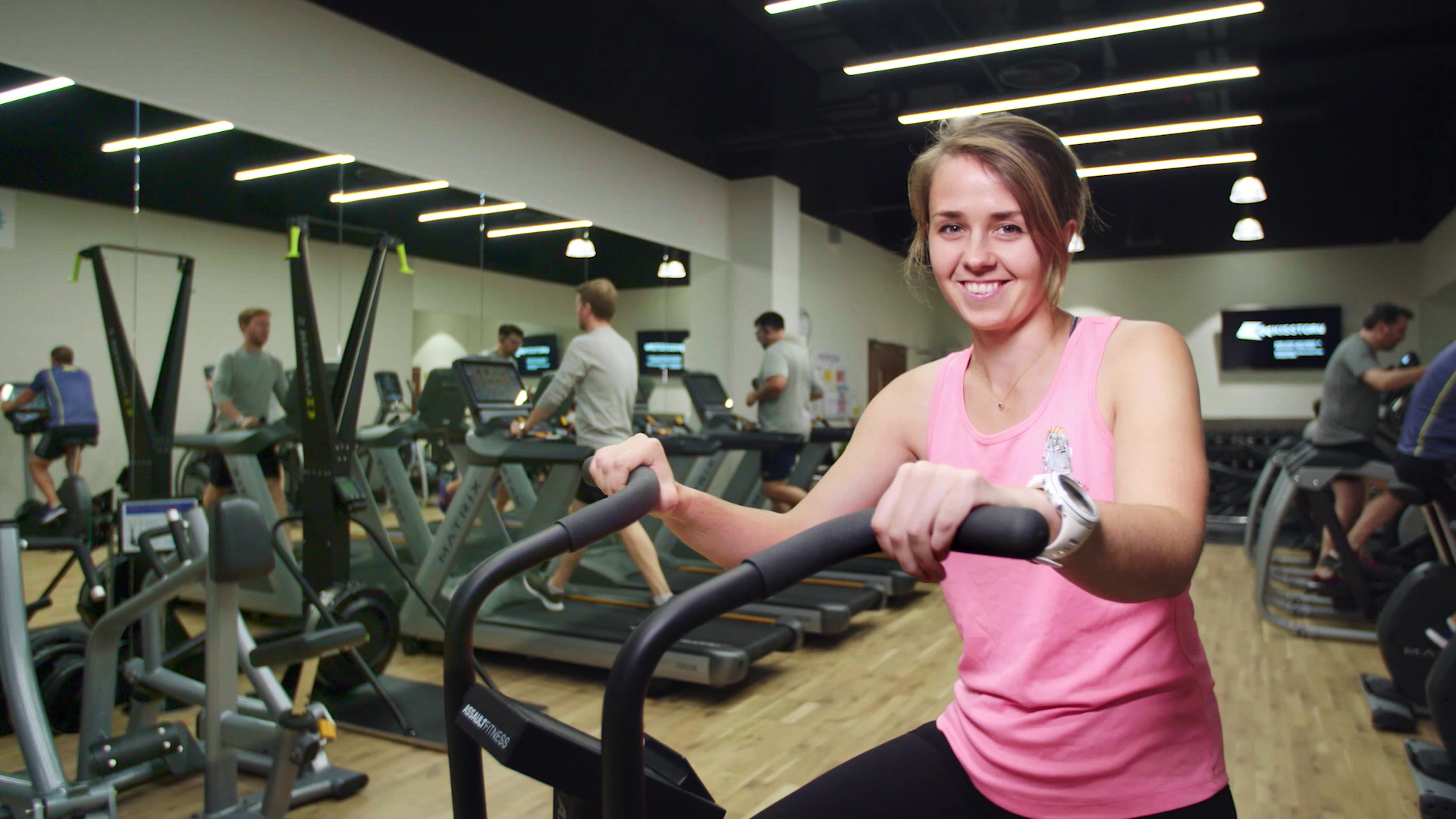 Woman in an office gymnasium smiling at the camera